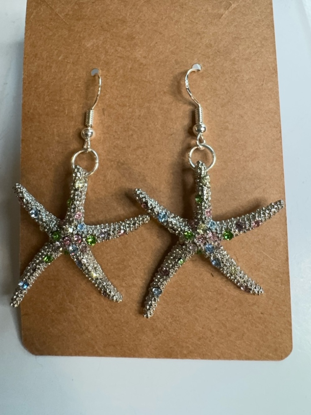 New silver tone starfish earrings